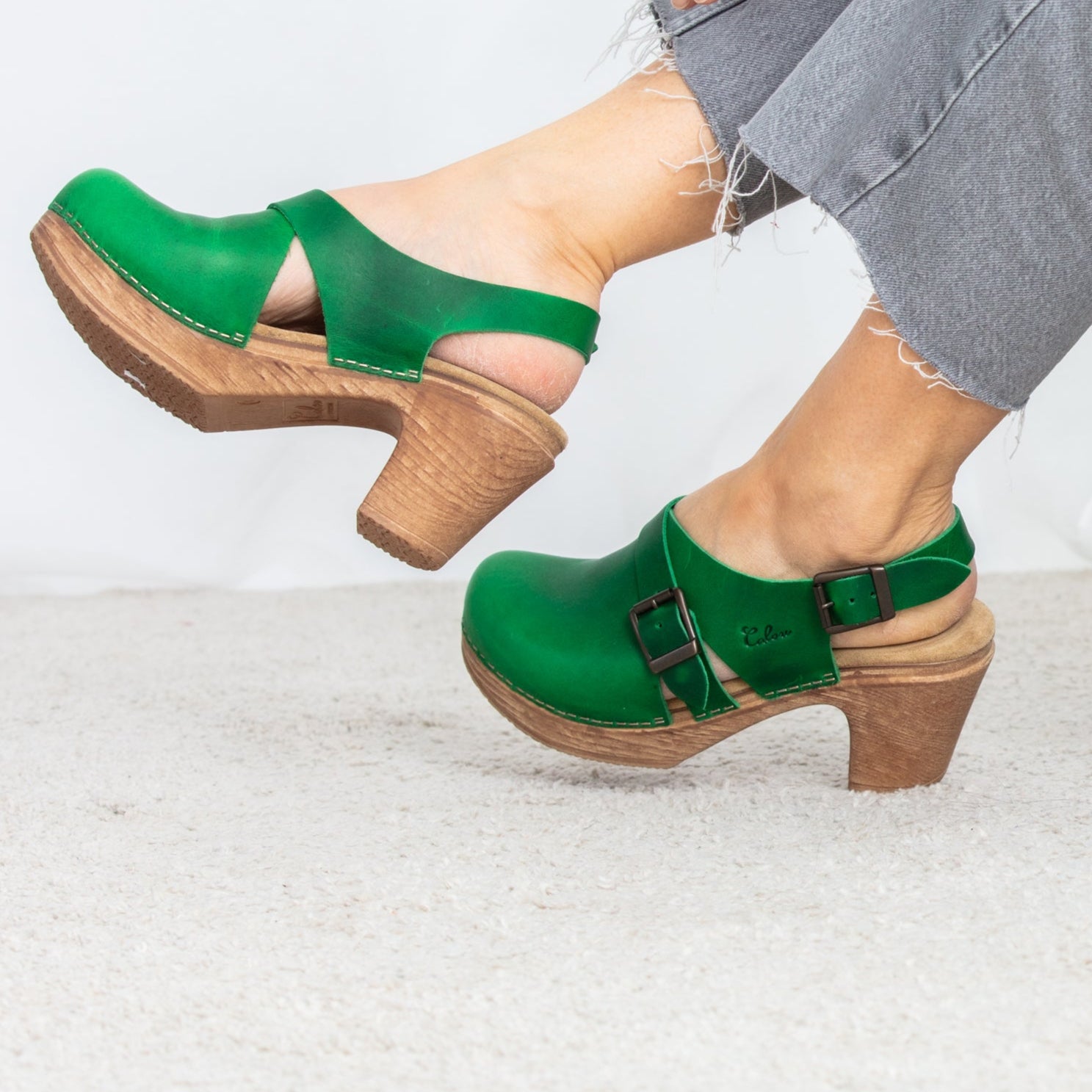 Astrid green leather clogsm with heel on model Calou Stockholm