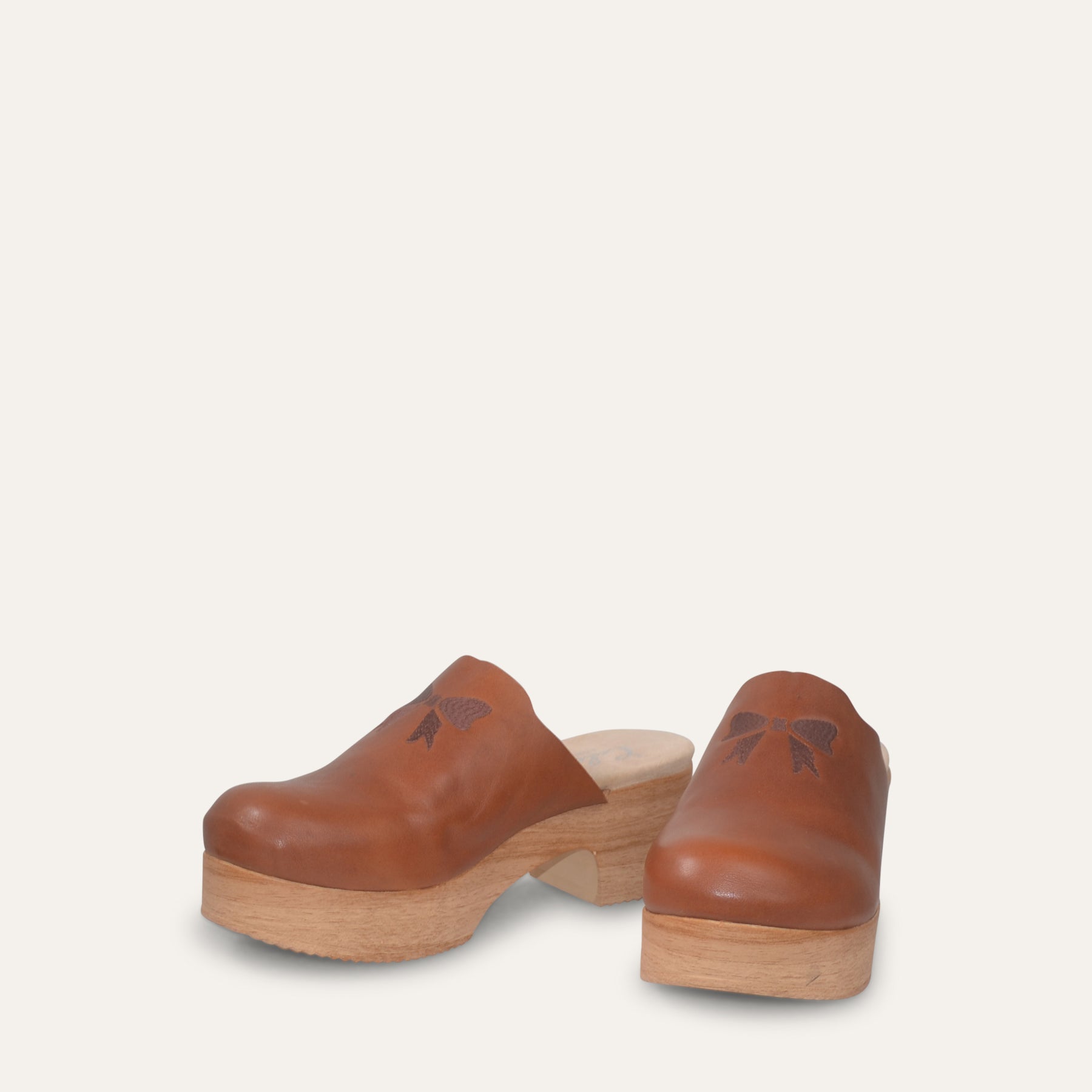 Calou Pair of brown leather clogs on flexible soles, front