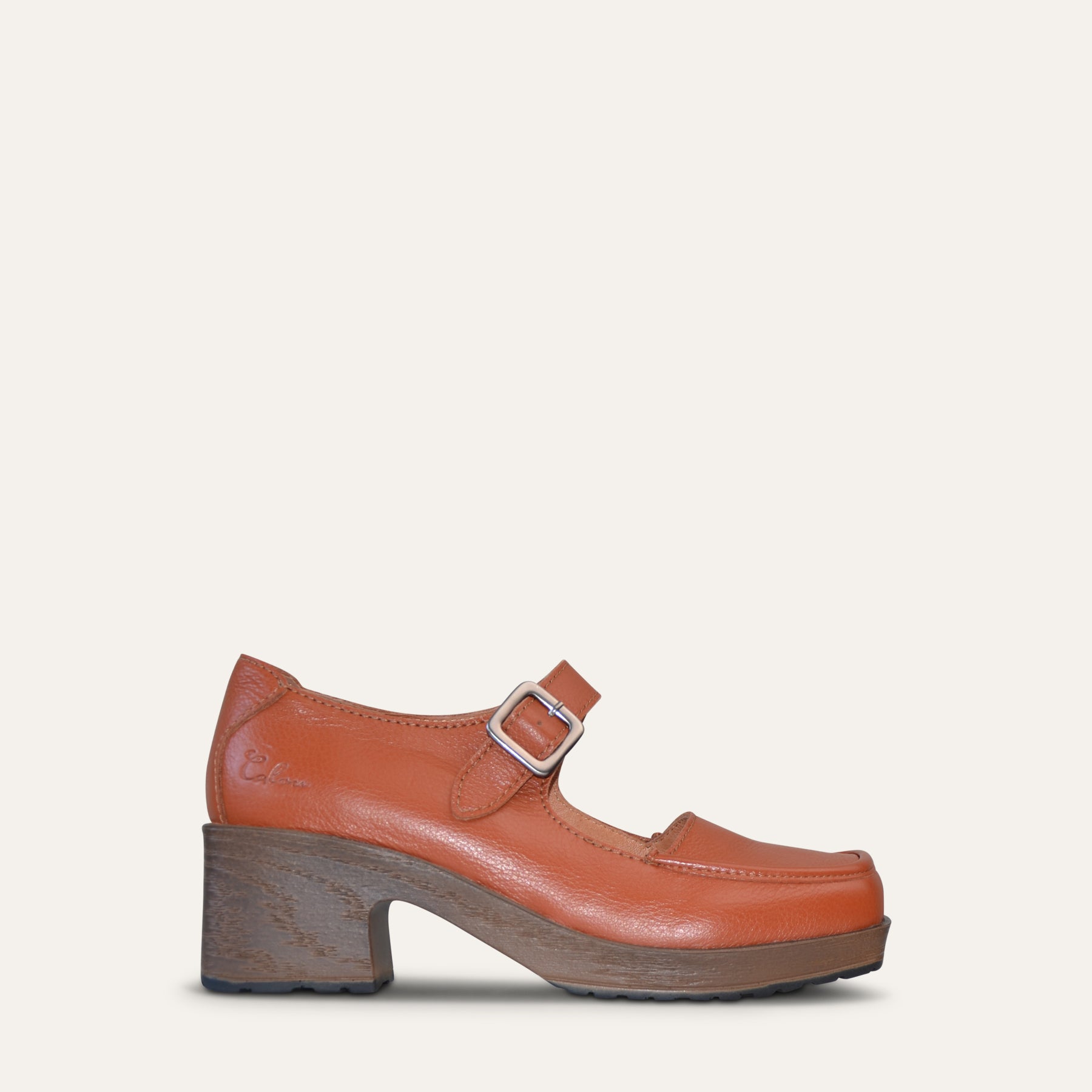 Calou Iwa Burnt orange leather Mary Jane clog with a buckle strap, wood-look heel, and soft, flexible, cushioned sole.