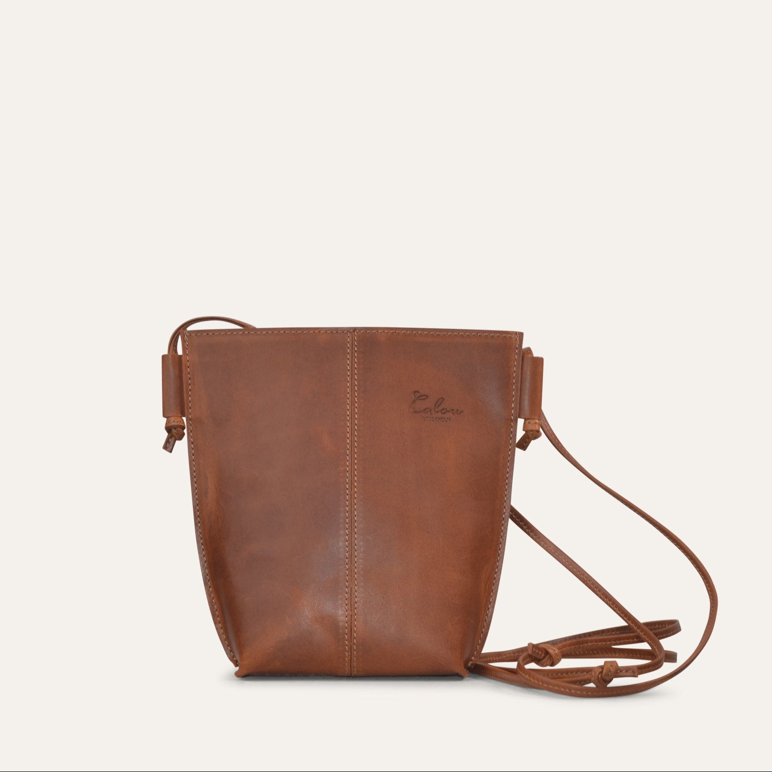 A small, sleek brown leather shoulder bag with an adjustable shoulder strap.