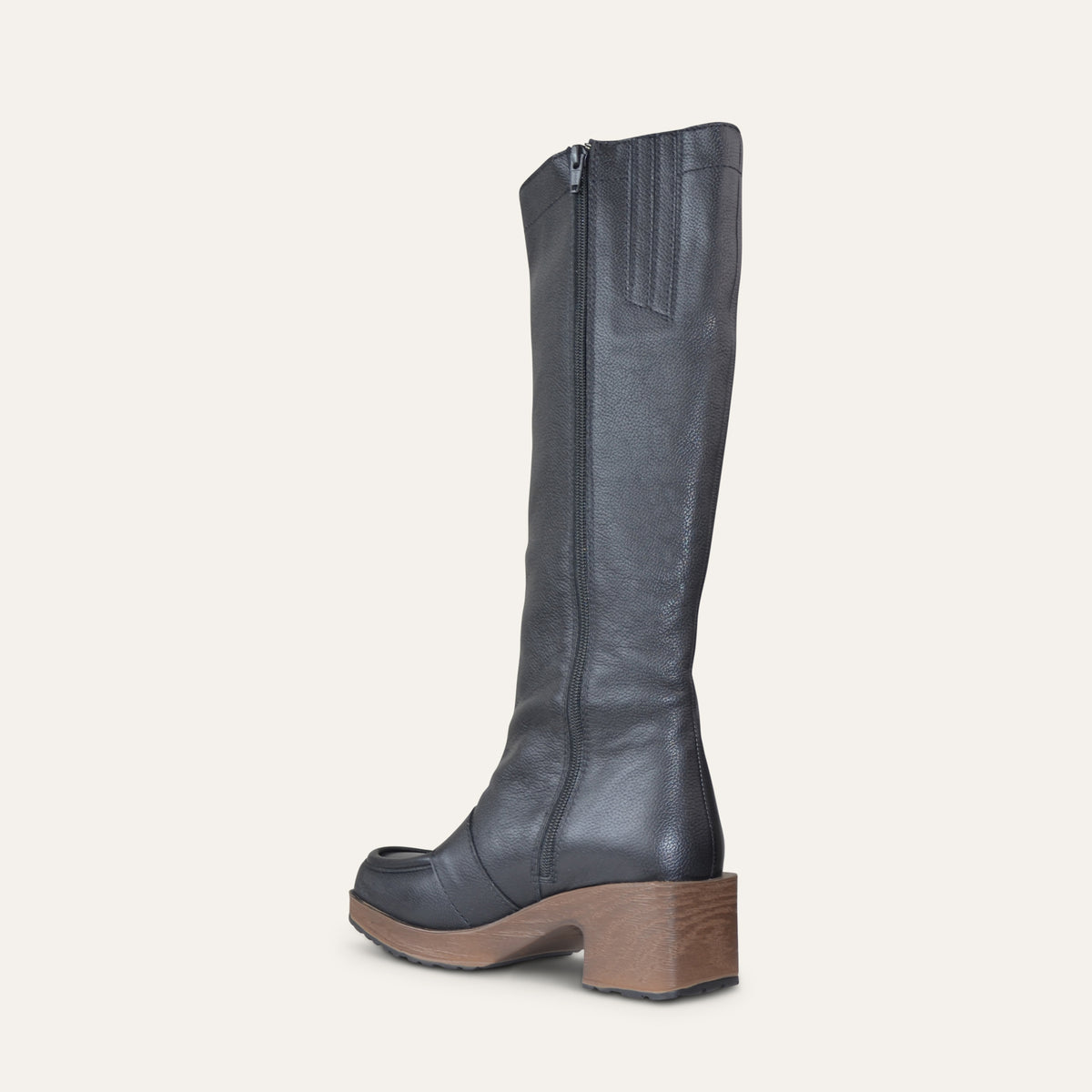 A single tall leather boot shown from the side profile against a solid off-white background. The boot is dark charcoal gray with a brown wooden block heel and sole.