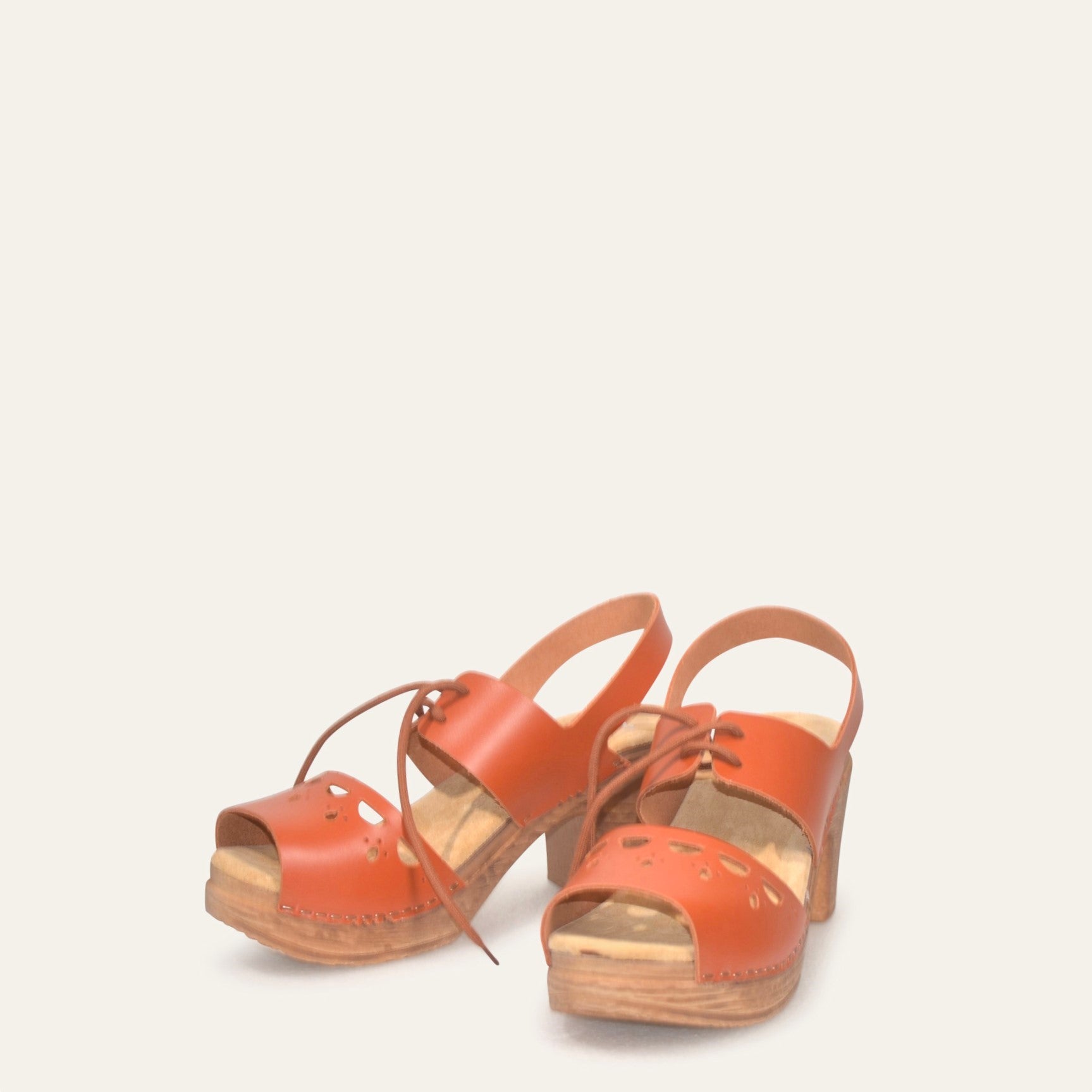 Frontview Orange leather clogs with cut out detail and flexible sole by Calou