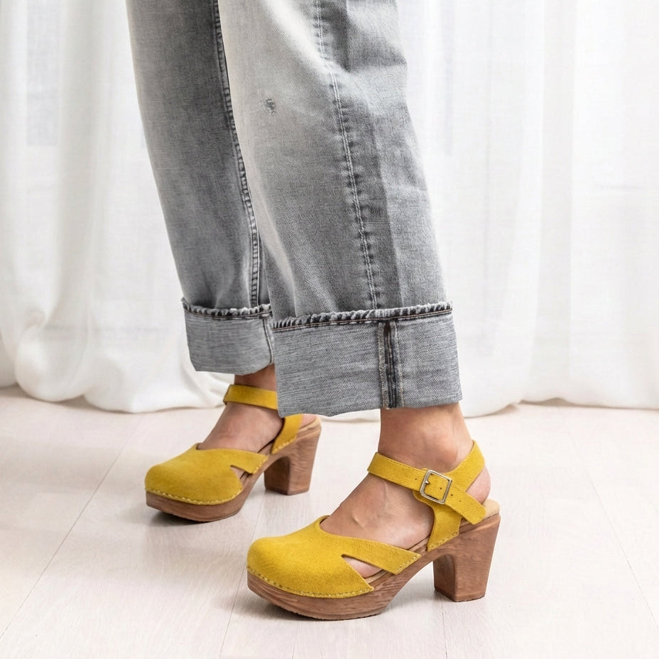 Yellow clogs worn with grey jeans by Calou
