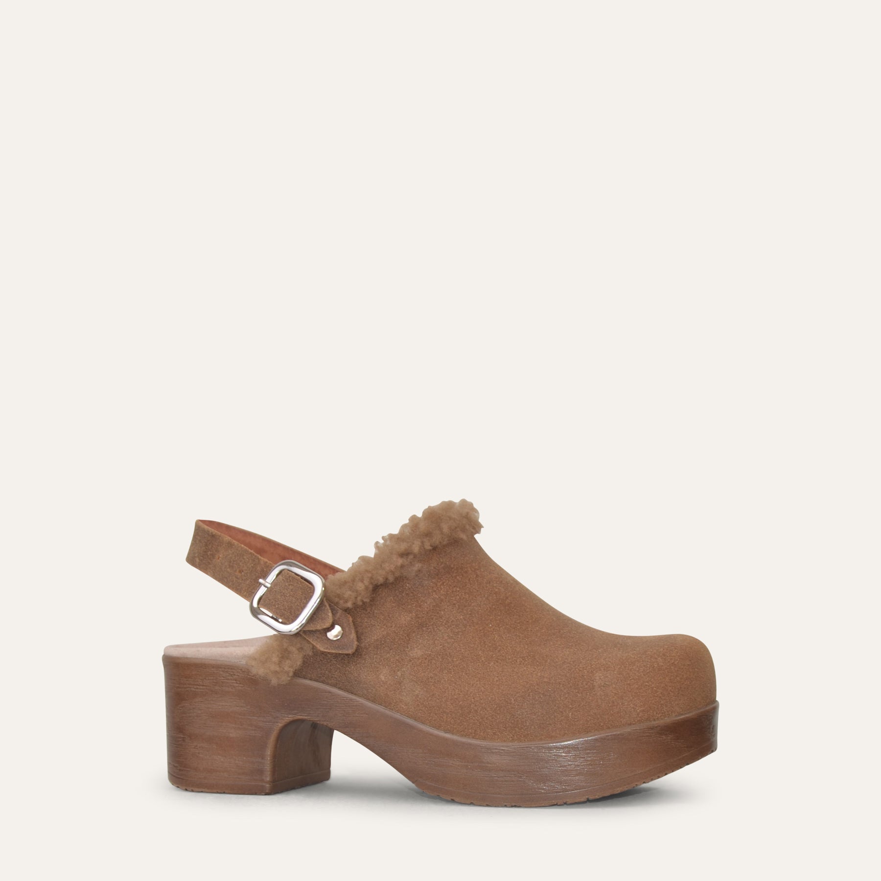 Brown suede clog shoe with a buckle on a white background